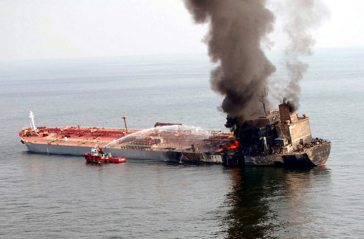 In a picture released by the Malaysian Police department Malaysian firefighter vessel sprays water onto a burning oil tanker, MT Formosa Product Brick, near the coast of Port Dickson, 50km south of Kuala Lumpur, on August 19, 2009, after it collided with another vessel. Fire crews on August 19 battled a blaze aboard a Taiwanese oil tanker carrying 58,000 tonnes of naphtha fuel in the Malacca Strait after it collided with another ship, Malaysian police said. Nine Chinese crew members were missing after the tanker collided with a Greek-managed bulk carrier vessel on the vital Asian shipping route. RESTRICTED TO EDITORIAL USE MALAYSIA OUT AFP PHOTO/HO/MALAYSIAN POLICE DEPARTMENT (Photo credit should read AFP/AFP/Getty Images)