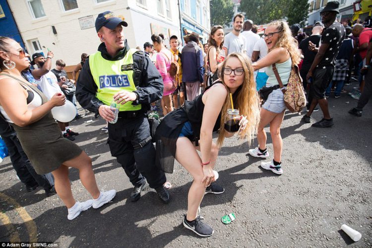 A young woman was seen dancing next to an on-duty police officer and performed the famous 'twerk' dance move