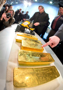Gold ingots are on display during a press conference of Germany's Central Bank in Frankfurt, Wednesday Jan. 16, 2013. Germany's central bank is to bring back home some US $36 billion ( 27 billion euro) worth of gold stored in the United States and France. The Bundesbank said in a statement Wednesday that it will repatriate all 374 tons of gold it had stored in Paris by 2020. An additional 300 tons - equivalent to 8 percent of the Bundesbank's total reserves worth about US $183 billion will also be shipped from New York to Frankfurt. Frankfurt will hold half of Germany's 3,400 tons of gold by 2020, with New York retaining 37 percent and London storing 13 percent. The move follows criticism from Germany's independent Federal Auditors' Office last year bemoaning the central bank's oversight of gold reserves abroad.(AP Photo/ dpa/ Frank Rumpenhorst)