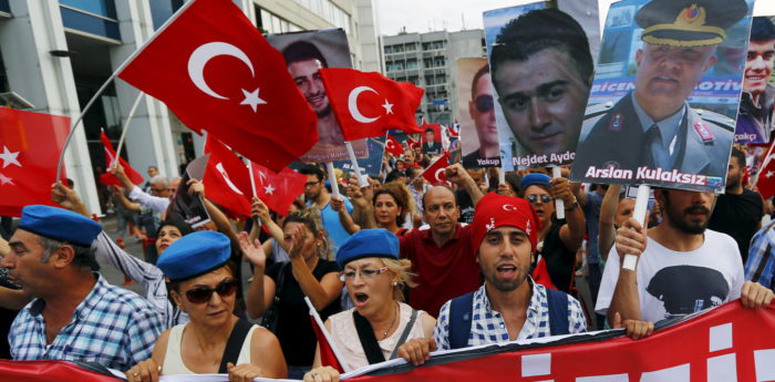 Demonstrators, wearing commando berets and holding pictures of the late Turkish army members who were killed by Kurdish militants, shout nationalist slogans during a protest against recent attacks on Turkish soldiers, in Istanbul, Turkey, September 7, 2015. Turkish warplanes bombed Kurdish insurgent targets overnight after the militants staged what appeared to be their deadliest attack since the collapse of a two-year-old ceasefire in July and killed 16 government soldiers. The military said its aircraft bombed 23 targets in a mountainous area near the Iraqi frontier on Monday. Another six soldiers had been wounded, but none were in critical condition. REUTERS/Murad Sezer - RTX1RIO1