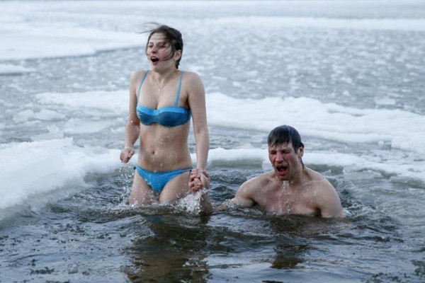 Couple takes dip in icy waters during celebrations for Orthodox Epiphany on Dnipro River in Kiev