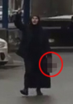 The woman was seen pulling the severed head out of a bag and walking around near the entrance to the metro station as police moved in