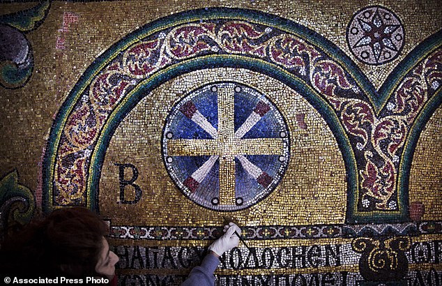 In this Feb. 4, 2016 photo, a restoration expert works on a mosaic inside the Church of the Nativity, in the West Bank city of Bethlehem. After two years of painstaking work, experts have completed the initial phase of a delicate restoration project at the Church of the Nativity, giving a much-needed face lift to one of Christianitys holiest sites. (AP Photo/Nasser Nasser)