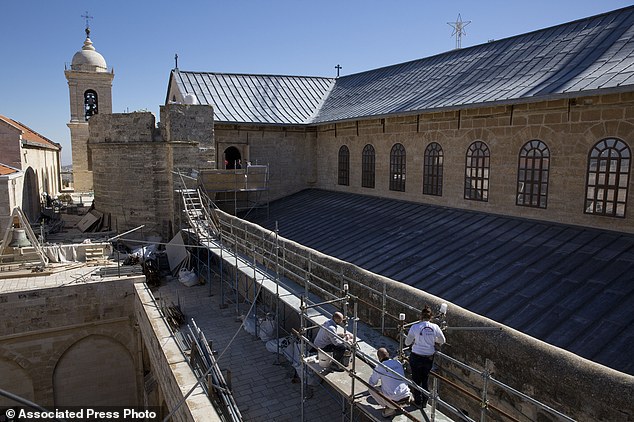 In this Feb. 4, 2016, photo, restoration experts work on the the rooftop of the Church of the Nativity, in the West Bank city of Bethlehem. After two years of painstaking work, experts have completed the initial phase of a delicate restoration project at the Church of the Nativity, giving a much-needed face lift to one of Christianitys holiest sites. The project, partially funded by the Palestinians and conducted by a team of Palestinian and international experts, is the biggest restoration at the iconic church in some 600 years. (AP Photo/Nasser Nasser)