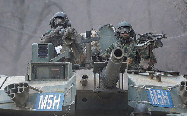 South Korean army soldiers ride a K-1 tank during the annual exercise in Paju, near the border with North Korea