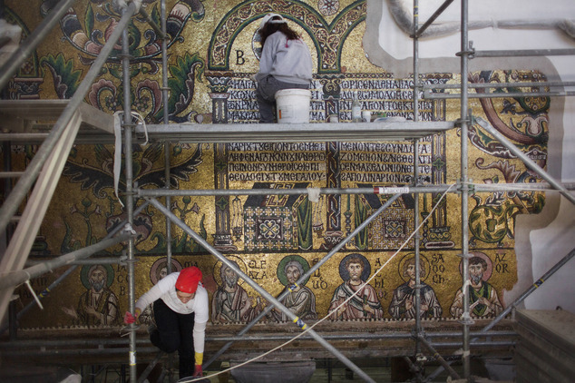 In this Feb. 4, 2016 photo, restoration experts work on mosaic inside the Church of the Nativity, in the West Bank city of Bethlehem. After two years of painstaking work, experts have completed the initial phase of a delicate restoration project at the Church of the Nativity, giving a much-needed face lift to one of Christianitys holiest sites. For the first time in almost 1,000 years the thousands of fine mosaics' tiles have been retouched. (AP Photo/Nasser Nasser)