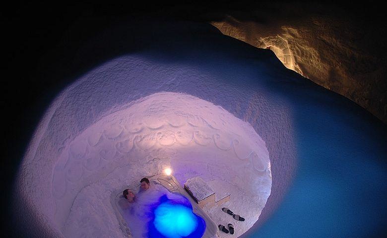 Despite being in the middle of winter, visitors enjoy the hot tub inside the igloo. 
