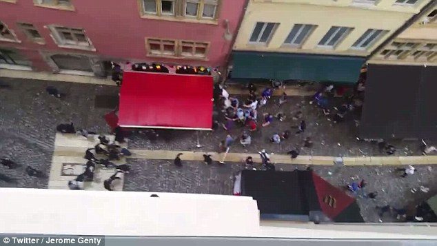 The 30-strong hooligan gang threw bottles and smashed up a bar while the travelling support were relaxing at British style pubs in Lyon. Footage recorded from above shows the group as they attack England fans